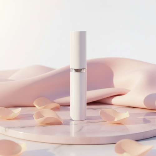 Premium lip gloss tube on pink marble with rose petals